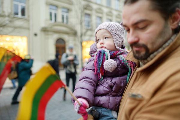 Father and daughter with a flag on Lithuanian independence day 