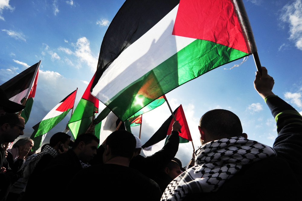 Erez Crossing: Palestinians Carry Palestinians Flags On Dec 31 2009.On April 2013, 132 (68.4%) Of The 193 Member States Of The United Nations Have Recognized The State Of Palestine. Stock Photo 146750888 : Shutterstock