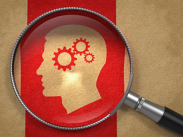 Magnifying Glass with Icon of Profile of Head with Cogwheel Gear Mechanism on Old Paper with Red Vertical Line Background. 